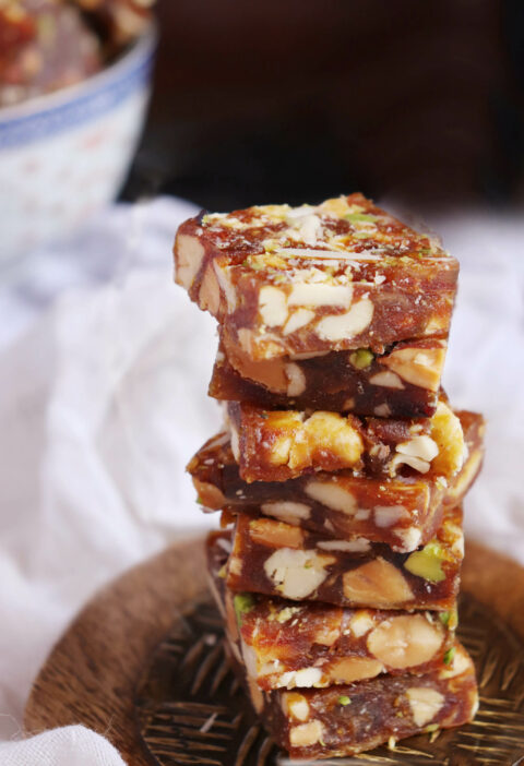 Khajur Dates Barfi stacked on a wooden plate